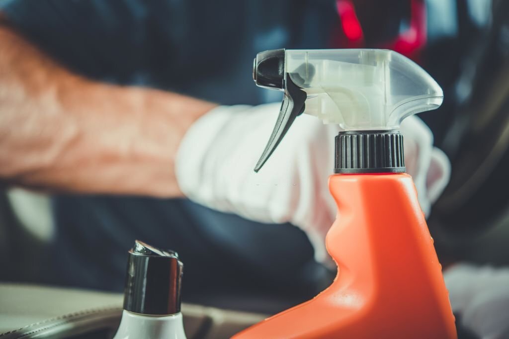 Orange Bottle of Cleaning Detergent Closeup Photo.