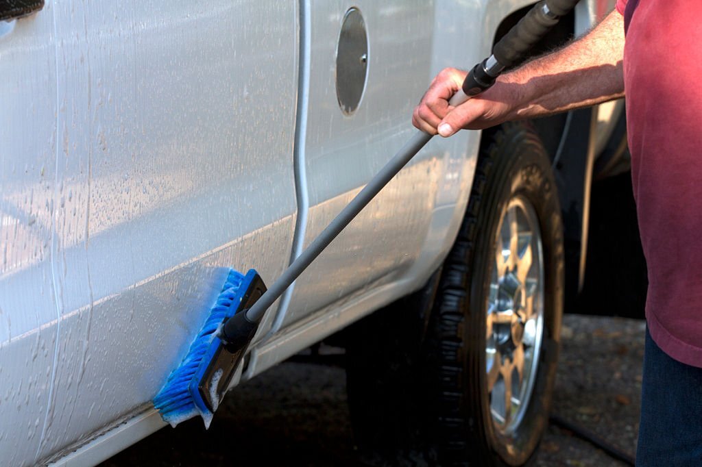 Washing a vehicle with a soapy brush