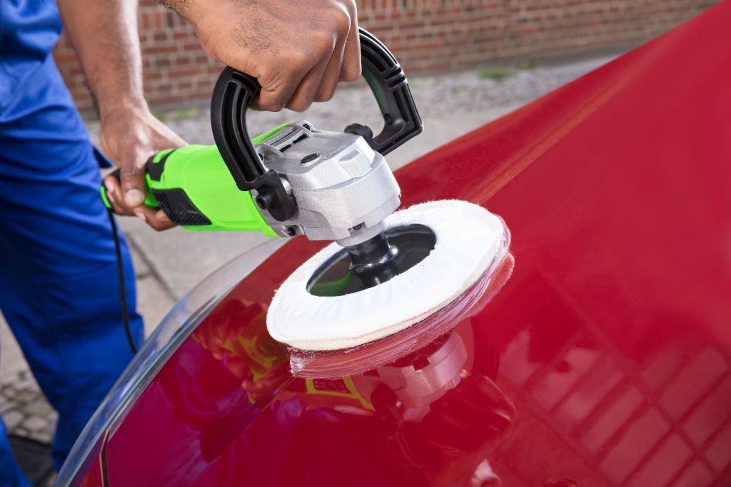 Close-up Of Person Hands Polishing Car With Orbital Polisher