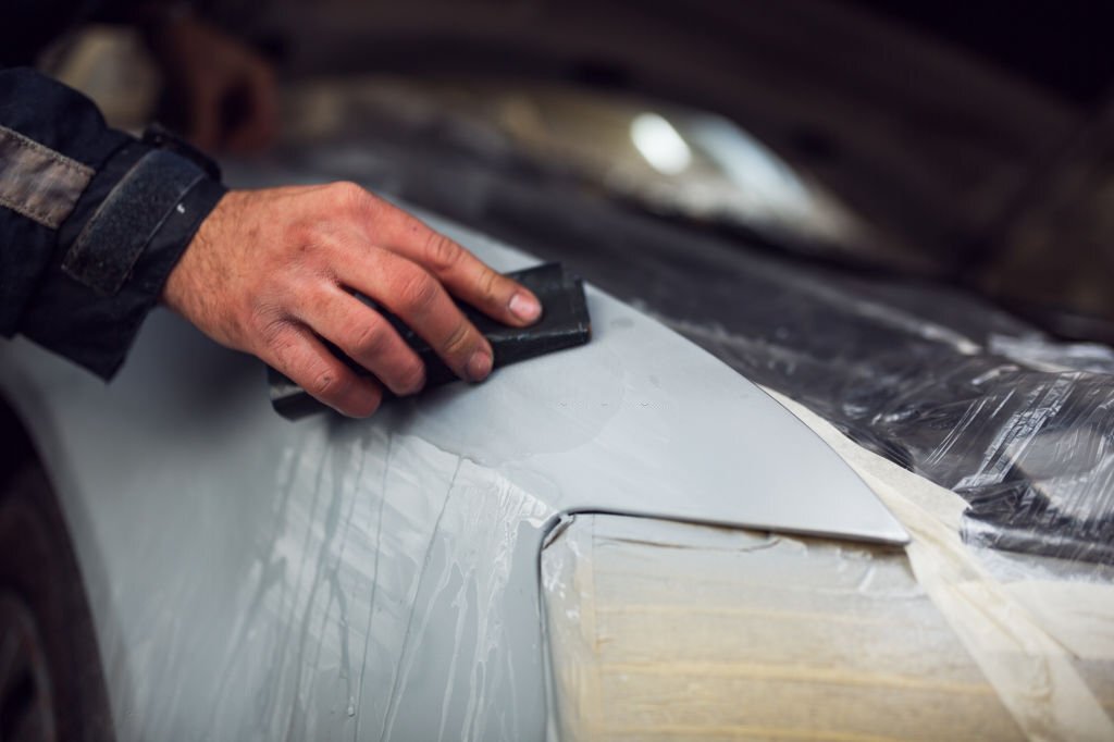 Man preparing car for painting procedure