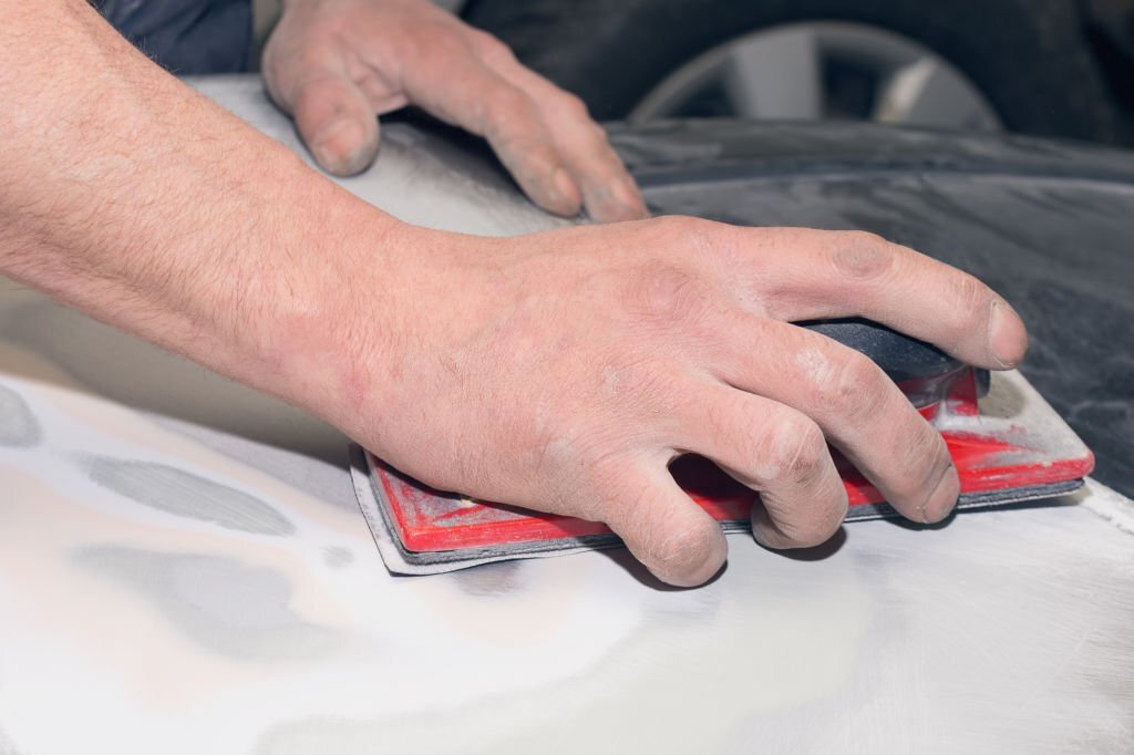 The master repairs the damaged part of the car after the accident. Body shop for car restoration.